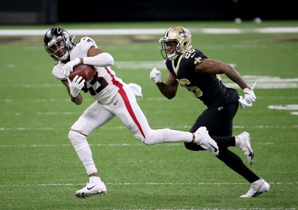 The Atlanta Falcons makes the catch as the New Orleans Saints defends.