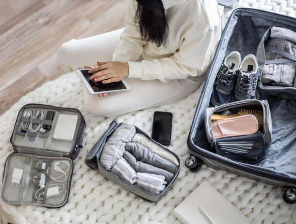 woman traveling and packing a suitcase