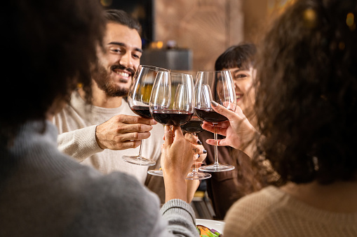 Friends toasting with a glass of wine