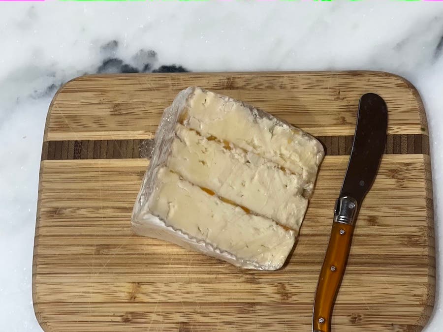 wedge of brie cheese with apricots