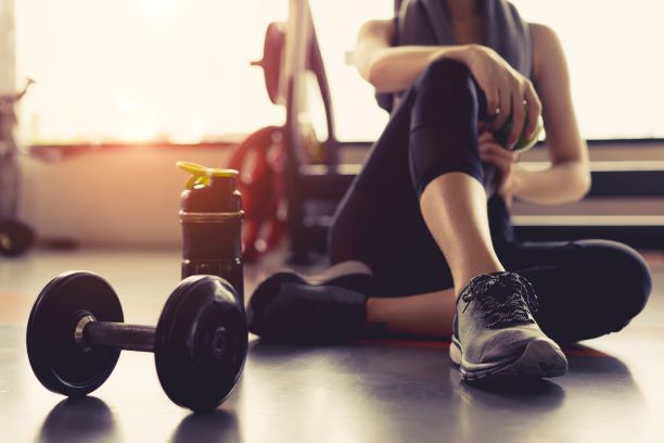 Woman working on out with weights in the gym