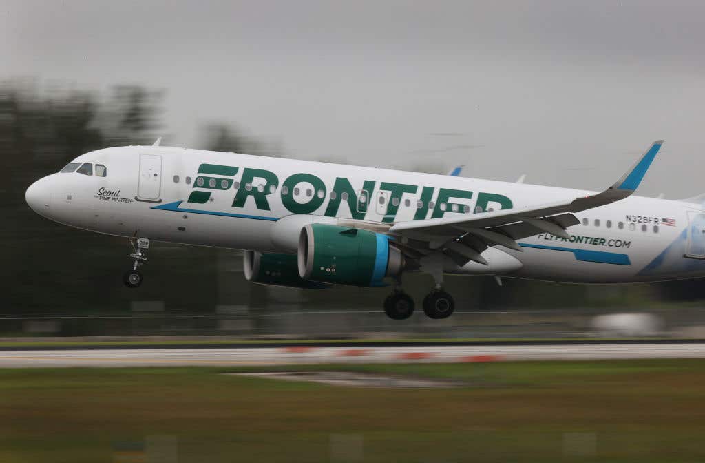 A Frontier airlines plane lands at the Miami International Airport