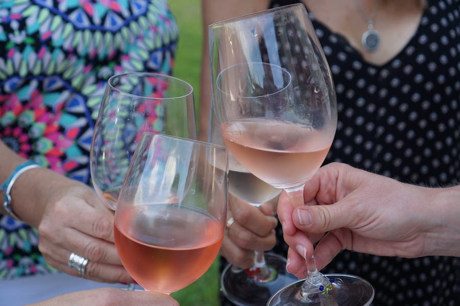 Three wine glasses clinking. Wines For "Girl Dinner"