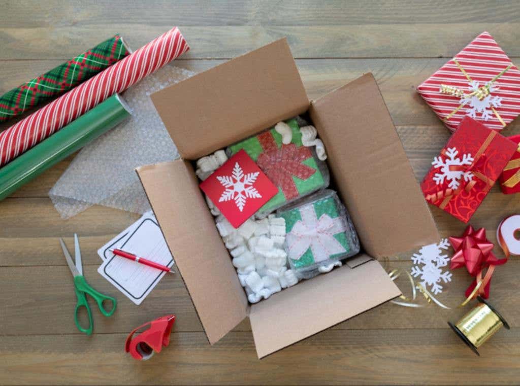 Flat lay Overhead Shot of Wrapped Christmas Presents in a Cardboard Shipping Box