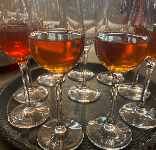 wine glasses on a serving platter, half full of rose for an Italian Wine Dinner