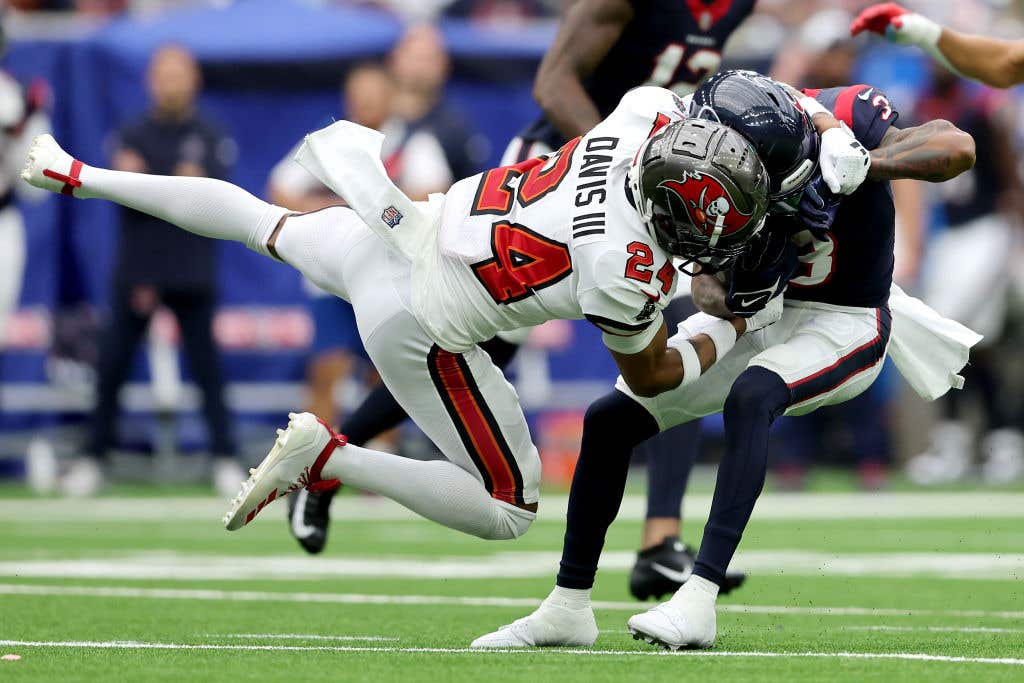 Carlton Davis III #24 of the Tampa Bay Buccaneers tackles Tank Dell #3 of the Houston Texans in the second quarter of a game at NRG Stadium on November 05, 2023 in Houston, Texas.