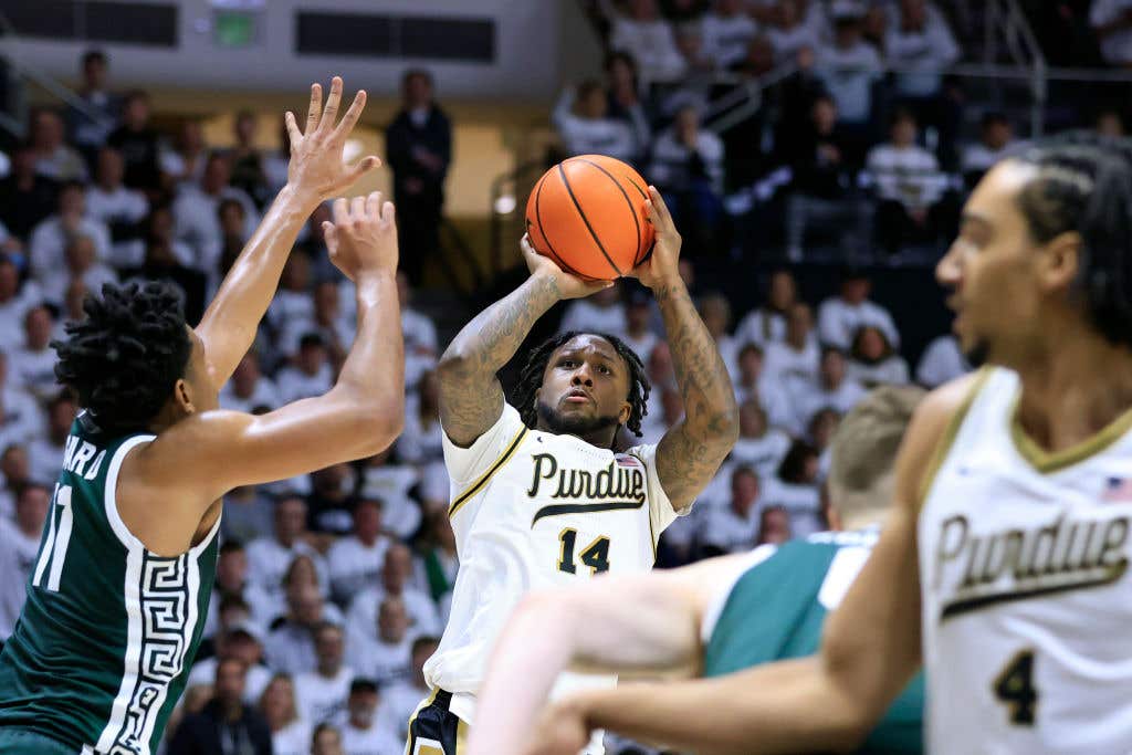 WEST LAFAYETTE, INDIANA - JANUARY 29: David Jenkins Jr. #14 of the Purdue Boilermakers takes a shot over A.J. Hoggard #11 of the Michigan State Spartans during the second half at Mackey Arena on January 29, 2023 in West Lafayette, Indiana.