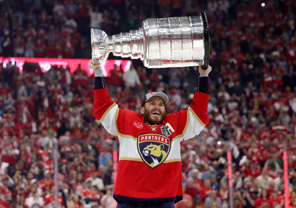 Matthew Tkachuk #19 of the Florida Panthers lifts the Stanley Cup after Florida's 2-1 victory against the Edmonton Oilers. The panthers brought the stanley cup to the beach