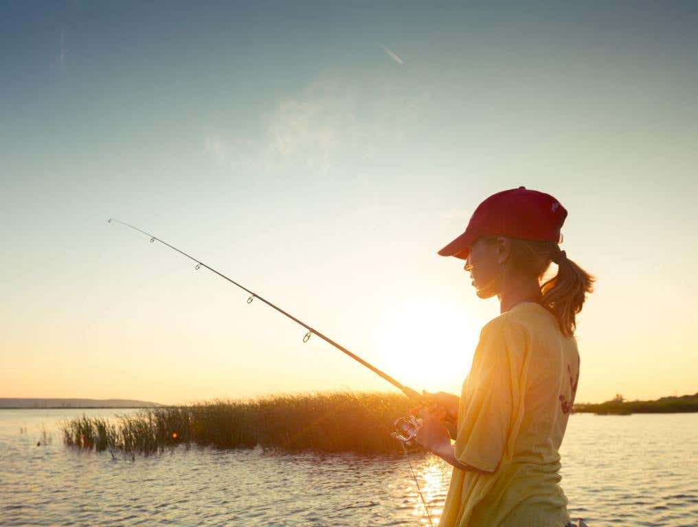 A woman fishing. If you love fishing, then note that one Florida lake has been named one of the best for fishing bass in America.