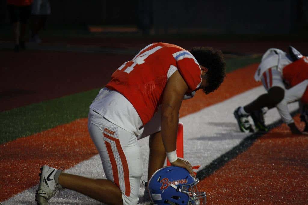 #44 Jadon Frick, previous player for Boone High School and currently a part of the Missouri Tiger Football team pictured praying prior to a game.