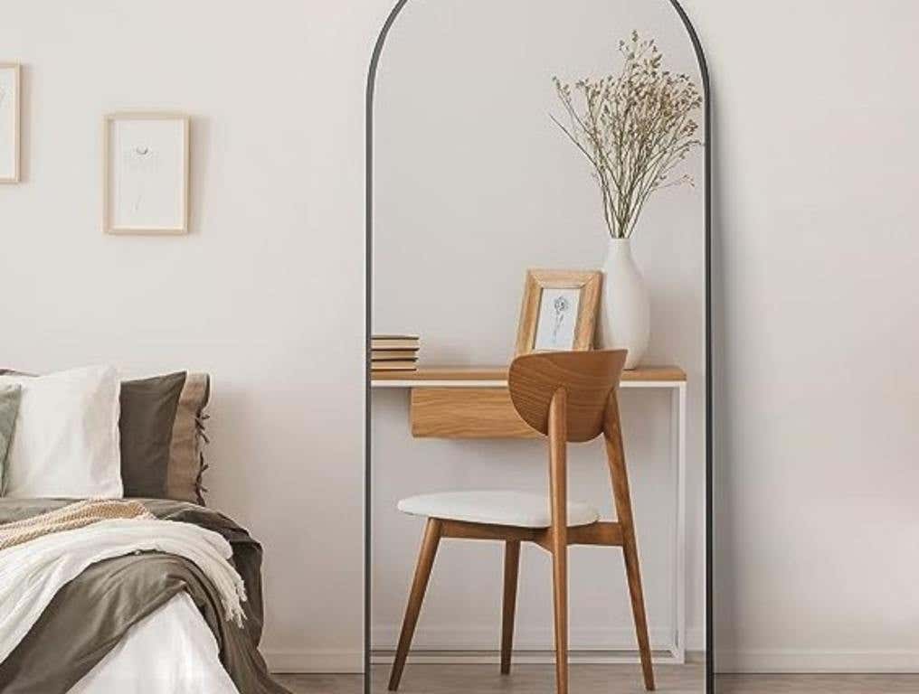 full length mirror in a bedroom