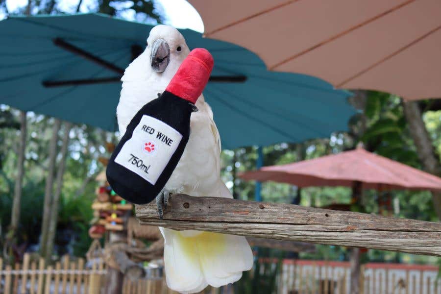 A white exotic bird with a stuffed wine bottle