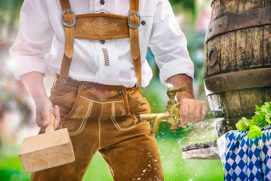 Man in German attire tapping a keg for Oktoberfest leads SWFL Weekend Events