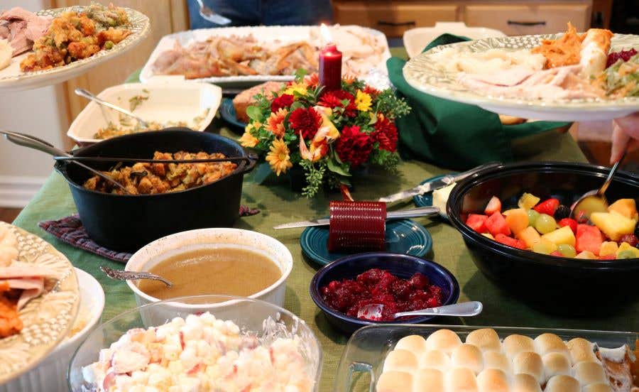 table full of side dishes for Thanksgiving dinner