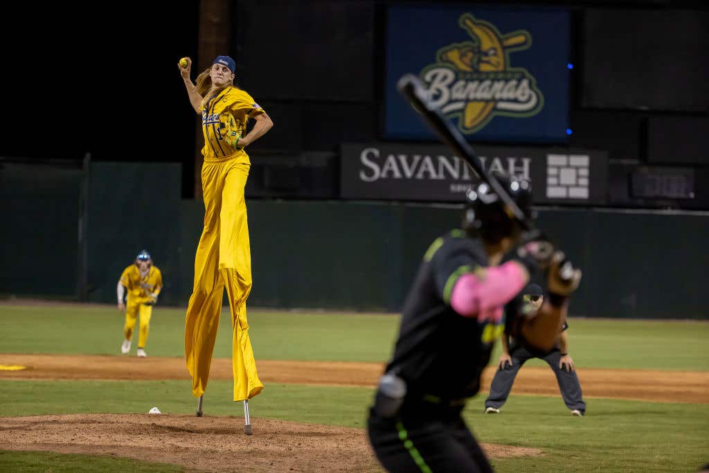 SAVANNAH, GEORGIA - MAY 11: Dakota "Stilts" Albritton #14 of the Savannah Bananas pitches against the Party Animals at Grayson Stadium on May 11, 2023 in Savannah, Georgia. Albritton plays Banana Ball on Stilts. He plays the field, bats, and he pitches all while wearing a pair of stilts while playing. The Historic Grayson Stadium is the home of the independent professional baseball team called the Savannah Bananas. The Bananas were part of the Coastal Plain League, a summer collegiate league, for seven seasons. In 2022, the Bananas announced that they were leaving the Coastal Plain League to play Banana Ball year-round. Banana Ball was born out of the idea of making baseball more fast-paced, entertaining, and fun. (Photo by Al Bello/Getty Images)