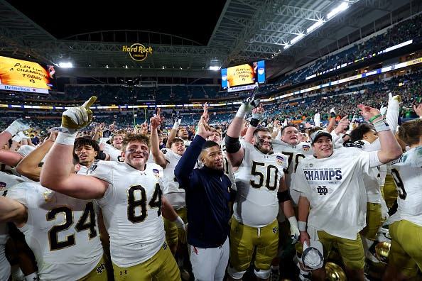 MIAMI GARDENS, FLORIDA - JANUARY 09: Head coach Marcus Freeman of the Notre Dame Fighting Irish celebrates with his team after defeating the Penn State Nittany Lions 27-24 in the Capital One Orange Bowl at Hard Rock Stadium on January 09, 2025 in Miami Gardens, Florida.