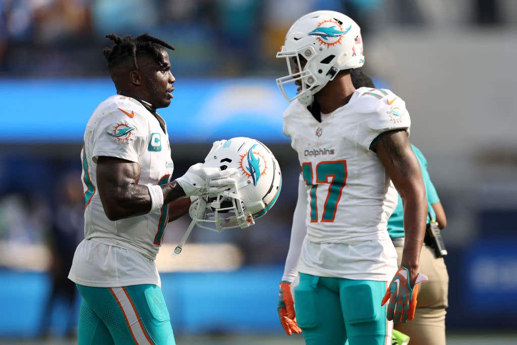 Tyreek Hill #10 talks with Jaylen Waddle #17 of the Miami Dolphins after a touchdown in the fourth quarter of a game against the Los Angeles Chargers