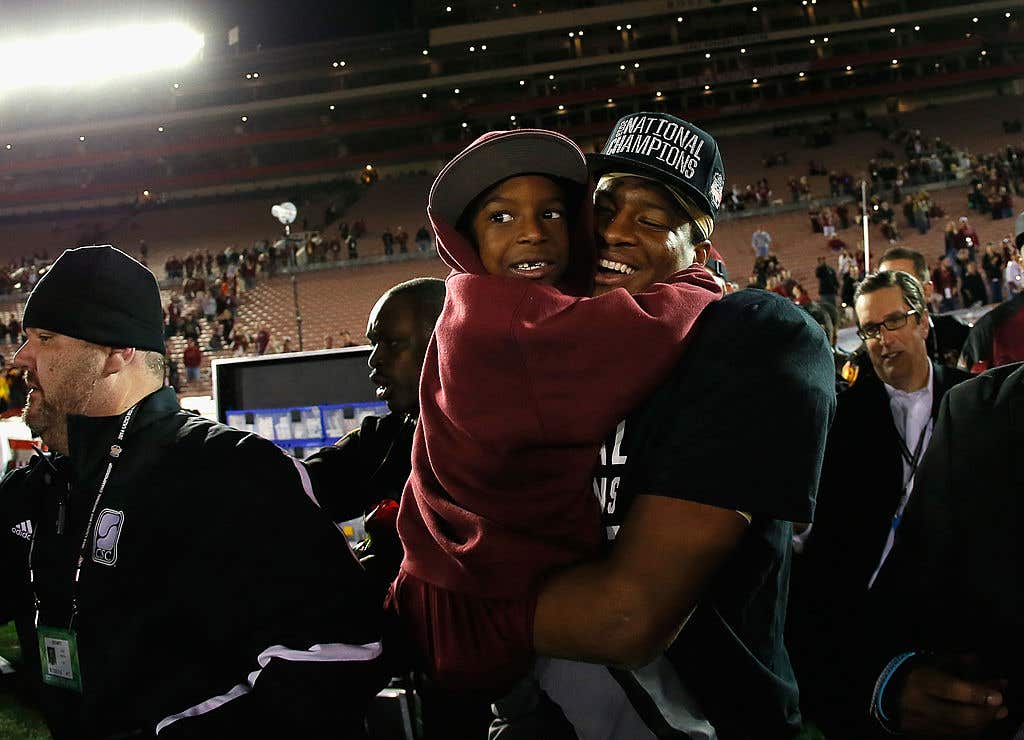 Quarterback Jameis Winston #5 of the Florida State Seminoles celebrates with his brother Jonah after defeating the Auburn Tigers 34-31