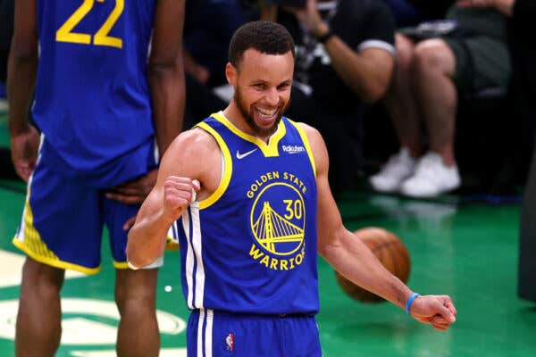 Steph Curry wearing his jersey and smiling during the 2022 NBA Finals