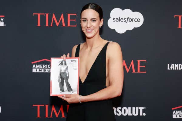 Caitlin Clark wearing a black dress holding a copy of Time magazine