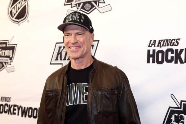 Mark Messier wearing a leather jacket and black hat