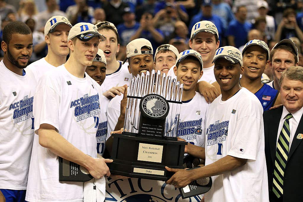 GREENSBORO, NC - MARCH 13: The Duke Blue Devils celebrate with the ACC Championship Trophy after their 75-58 victory over the North Carolina Tar Heels in the championship game of the 2011 ACC men's basketball tournament at the Greensboro Coliseum on March 13, 2011 in Greensboro