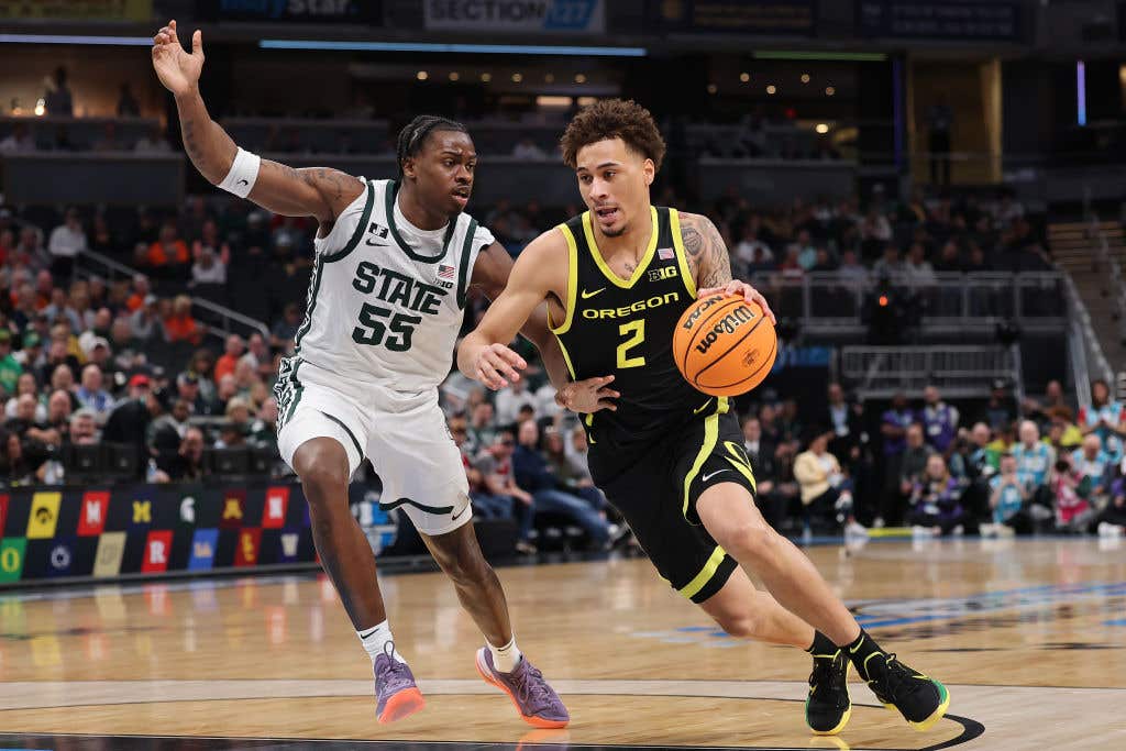 Jadrian Tracey #2 of the Oregon Ducks drives to the basket against Coen Carr #55 of the Michigan State Spartans during the first half in the Big Ten men's basketball tournament quarterfinals